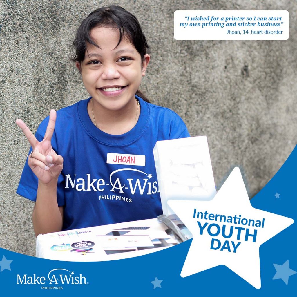Young girl who wished for gadgets posing with a printer and a peace sign from Make-A-Wish Philippines